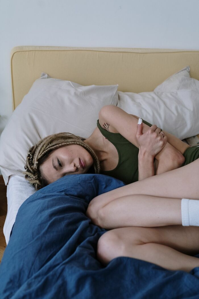 A woman lies in bed looking upset, representing heartbreaking moments a marriage was over.