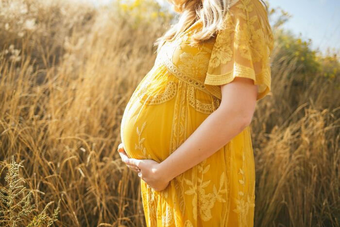 A pregnant woman, contemplating past friendships and potential haters.