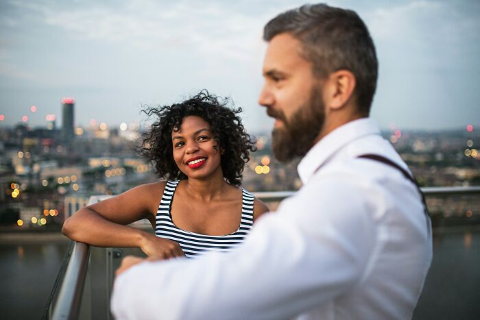 A woman smiling, oblivious that her friends were actually her haters.