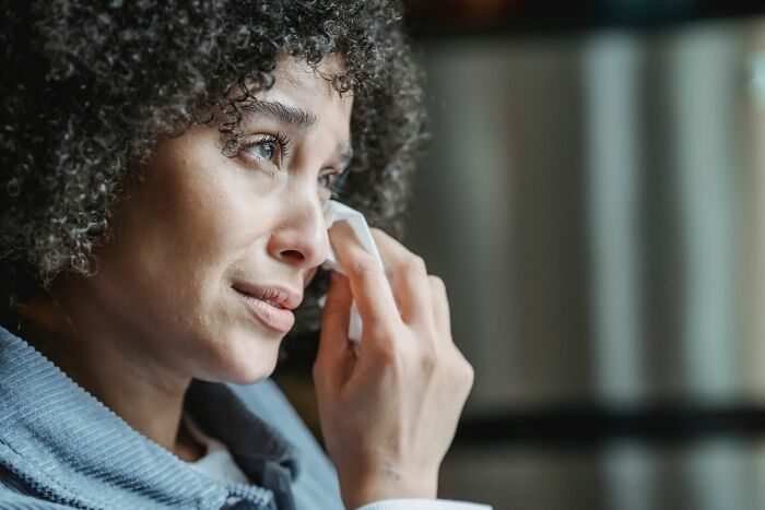 A woman crying, realizing that her friends were actually her haters.