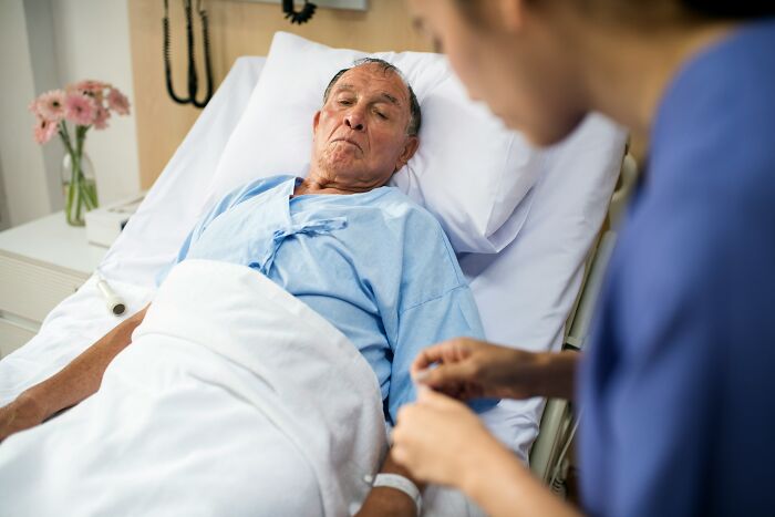 Elderly patient in hospital bed, attended by a nurse, revealing secrets after people keeping them were gone.