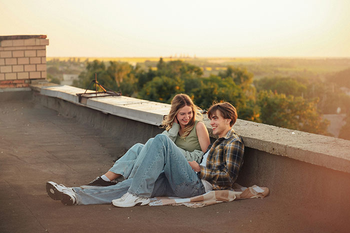 A happy couple sitting on a rooftop at sunset, before she suddenly leaves while he's at work. A happy couple sitting on a rooftop at sunset, before she suddenly leaves while he's at work.