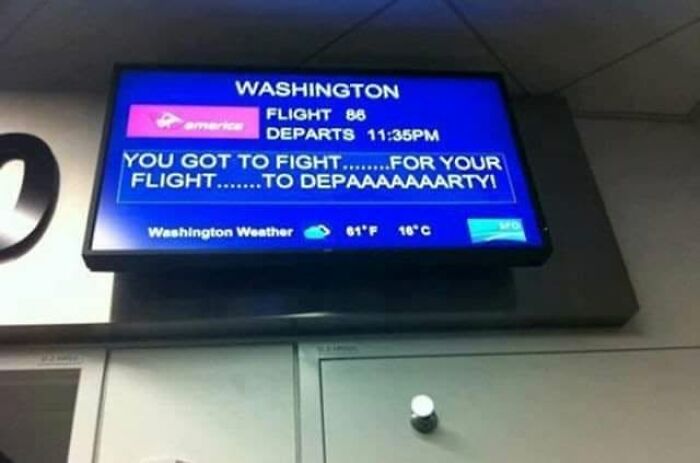 A funny flight departure board displaying a humorous message about fighting for the flight, a weird thing spotted at airports.