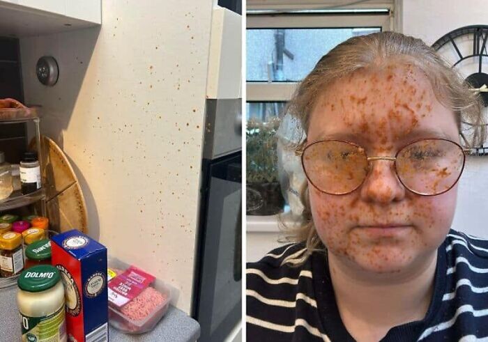 A woman with spaghetti sauce splattered on her face and glasses, alongside a sauce-splattered kitchen wall, a messy kitchen fail.
