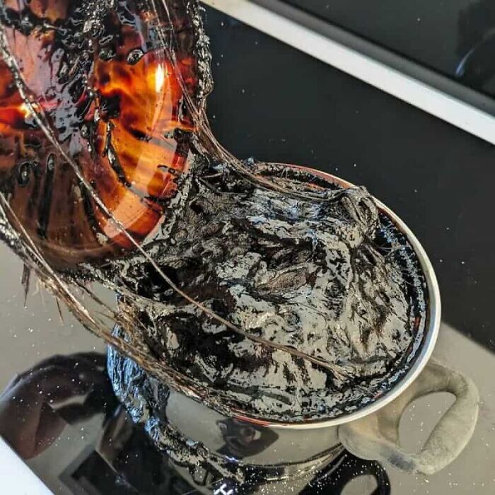 A melted plastic item creating a sticky black mess, one of the many kitchen fails.