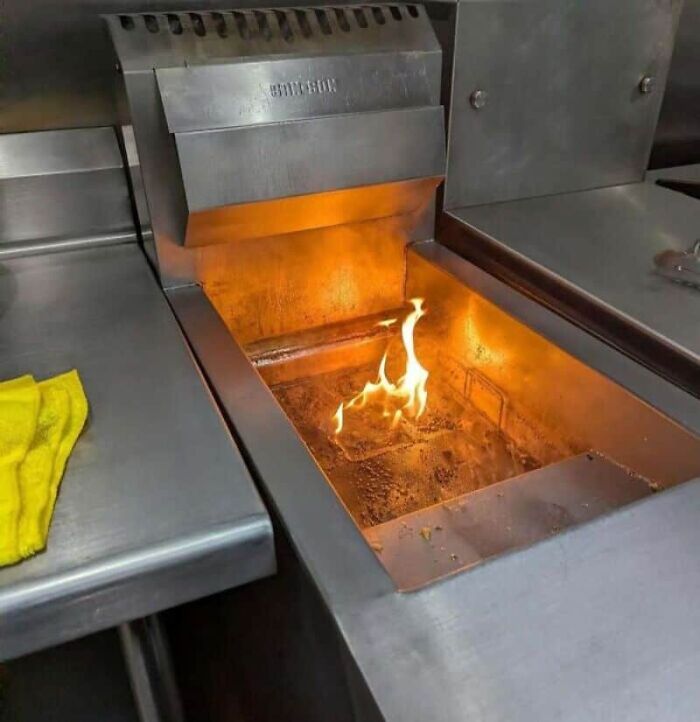 Flames inside a metal commercial kitchen range, an example of kitchen fails.