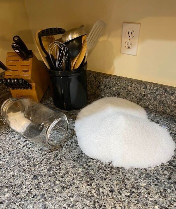 A spilled container of salt on a kitchen counter, a common kitchen fail.