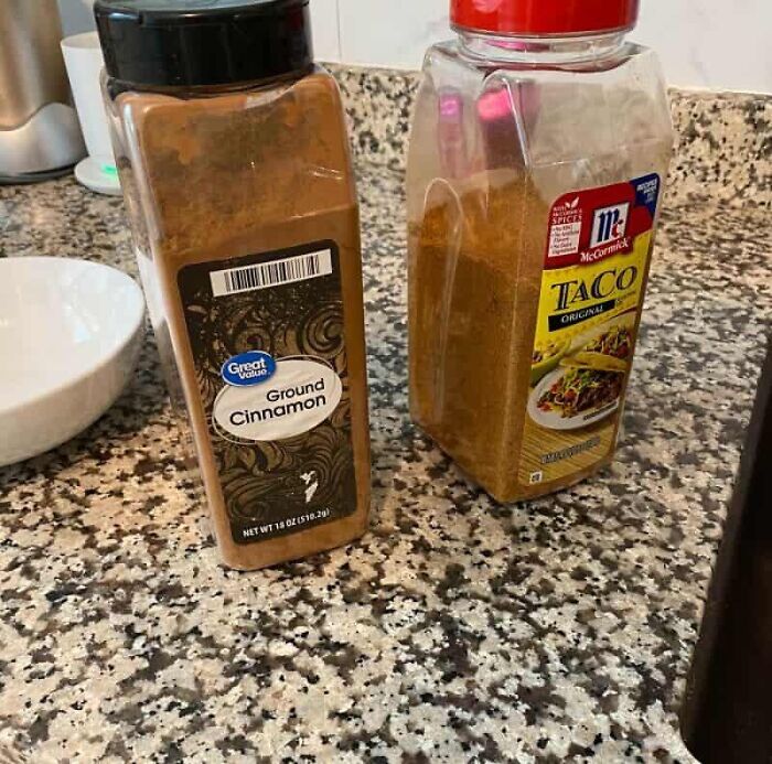 A ground cinnamon container next to a taco seasoning container, a kitchen fail mix-up.