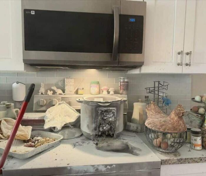 A kitchen covered in white powder, likely from an exploded appliance, showcasing a massive kitchen fail.