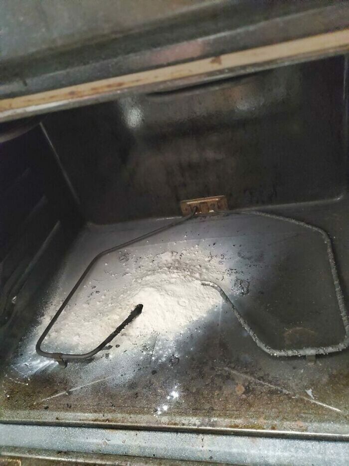 Interior of an oven with a burnt heating element and white residue, a significant kitchen fail.