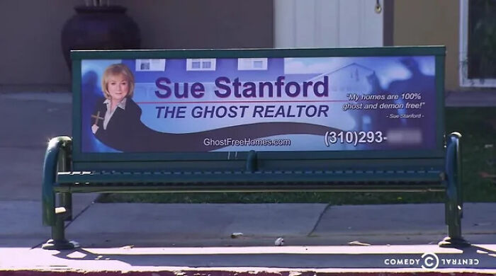 A bench advertising sign for a ghost realtor, representing unusual signs