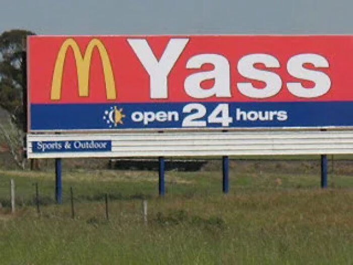Large McDonald's billboard with the word Yass on it as an unusual sign from around the world.