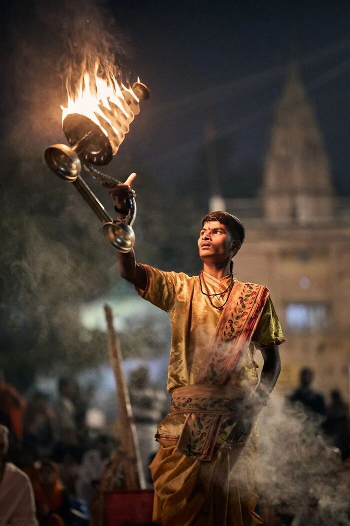 A man in traditional attire performs a ritual with fire, capturing remarkable places and people.