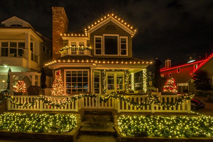 A house elaborately decorated with Christmas lights, showcasing surprising things wealthy people buy.