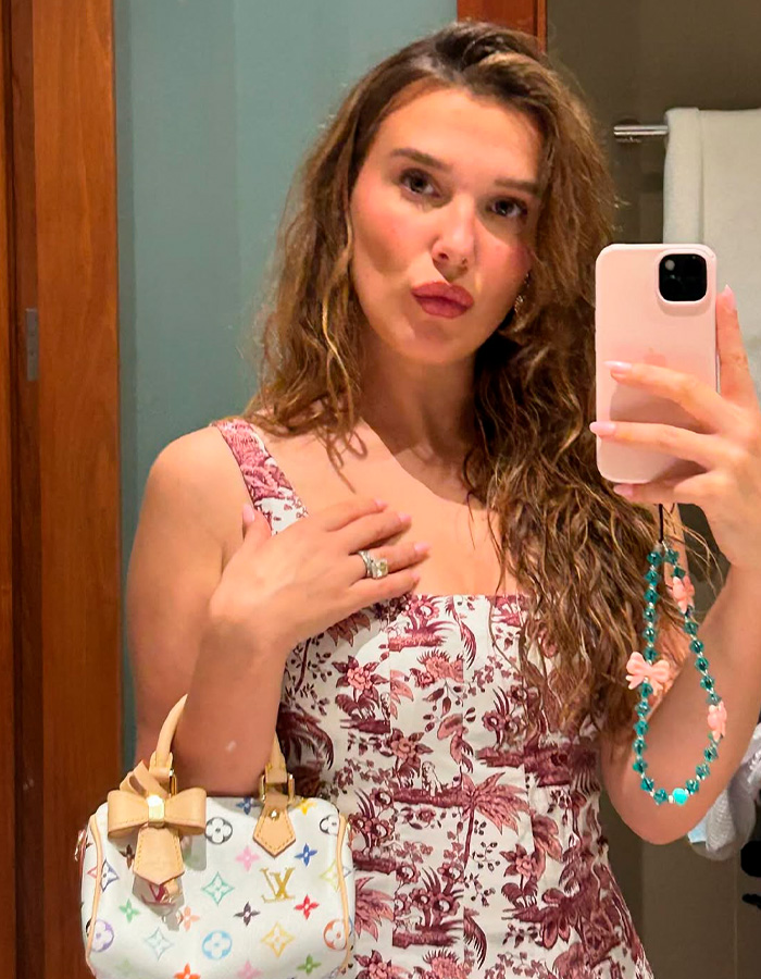Woman taking mirror selfie showing running without a bra pose Woman taking mirror selfie showing running without a bra pose