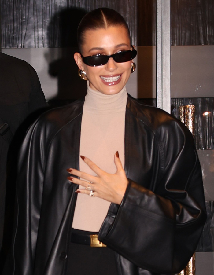 Gen Z bold new pose showcased by woman in black leather jacket and sunglasses Gen Z bold new pose showcased by woman in black leather jacket and sunglasses