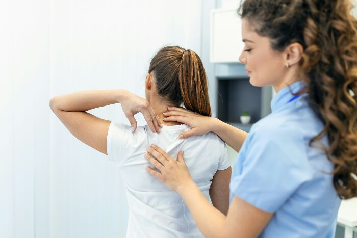 A female doctor performs a physical exam, part of the standard medical procedures doctors do.