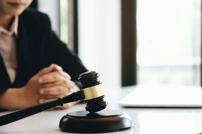 A close-up of a wooden gavel on a desk, representing the arguments heard in court.