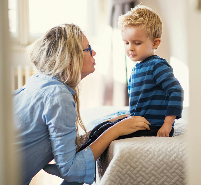 A mother and her young child engaging in a serious conversation, showing parents understanding their children.