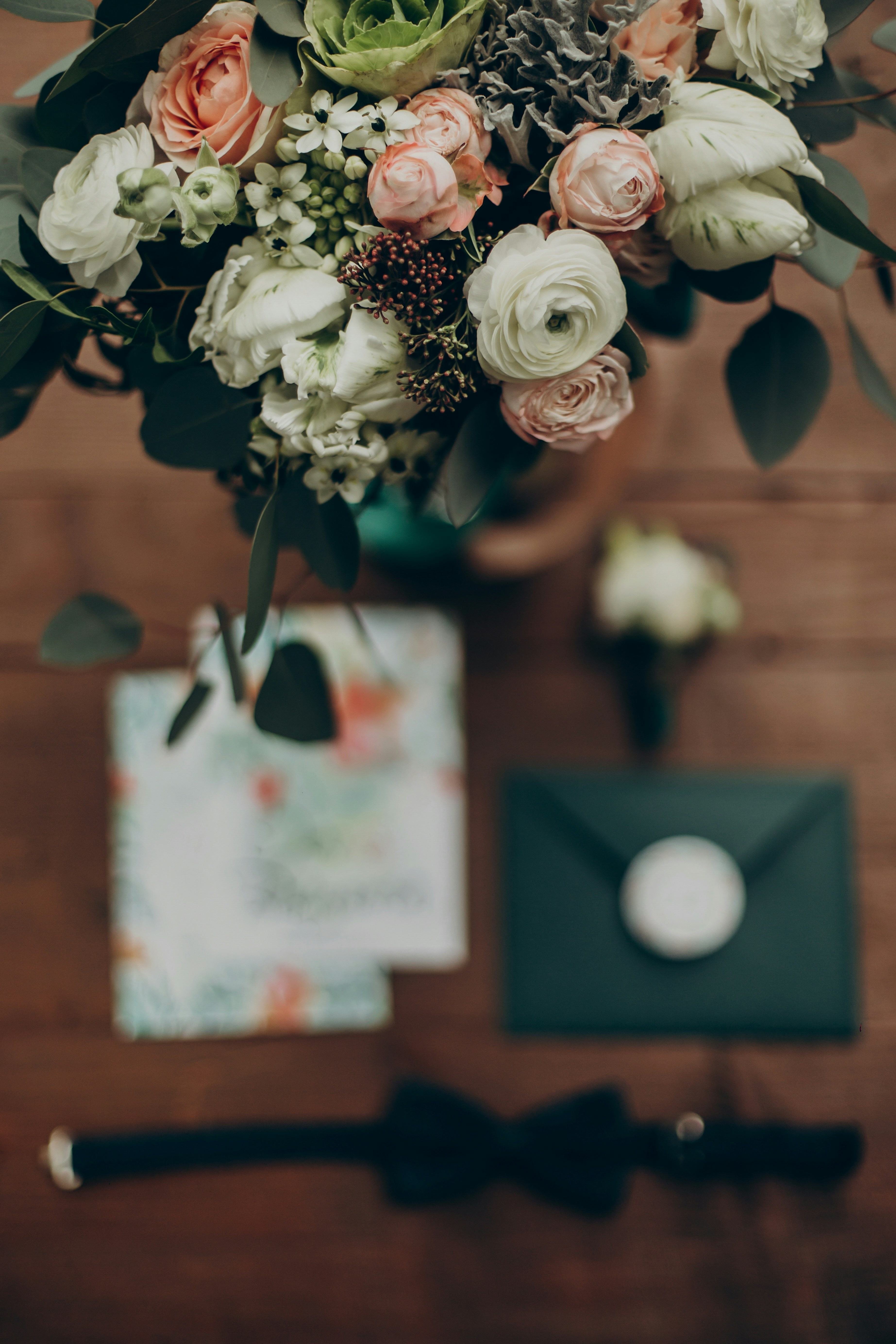 A beautiful wedding bouquet with an invitation, a bow tie, and a boutonniere, representing a wedding celebration. A beautiful wedding bouquet with an invitation, a bow tie, and a boutonniere, representing a wedding celebration.