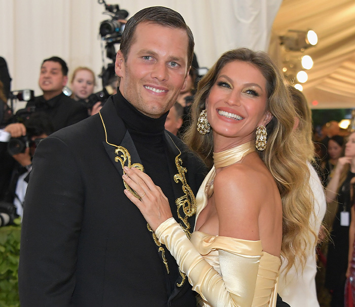 Gisele Bündchen and Tom Brady smiling together at a formal event Gisele Bündchen and Tom Brady smiling together at a formal event