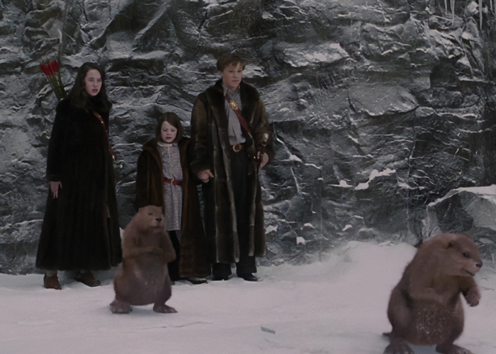 Characters in a fantasy adaptation scene with beavers, amidst religious backlash.