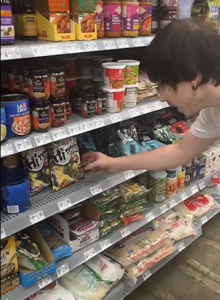 A man looking for actual food in a grocery store, with American parents filling a whole cart of groceries. A man looking for actual food in a grocery store, with American parents filling a whole cart of groceries.