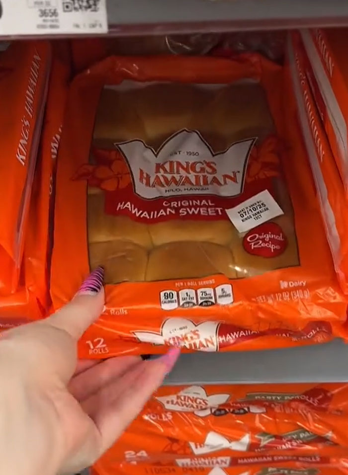 American parents shopping for groceries; hand picking a package of King's Hawaiian sweet bread from a grocery store shelf. American parents shopping for groceries; hand picking a package of King's Hawaiian sweet bread from a grocery store shelf.