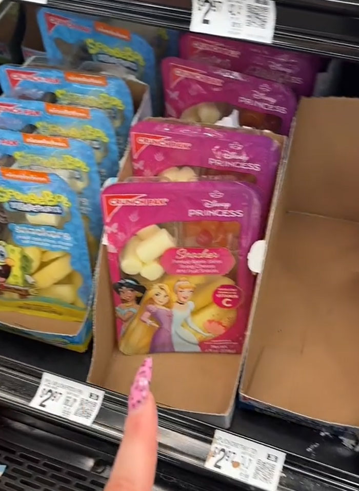 American parents fill cart with groceries: pre-packaged Disney Princess snacks and Spongebob fruit pouches. American parents fill cart with groceries: pre-packaged Disney Princess snacks and Spongebob fruit pouches.