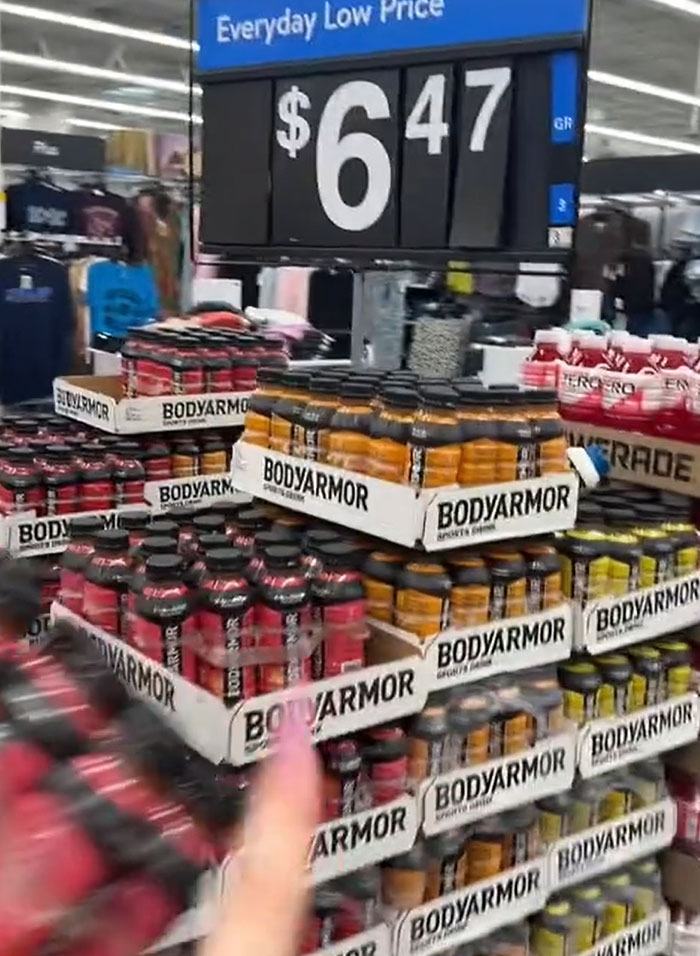 American parents fill cart with groceries: a display of Bodyarmor sports drinks at an Everyday Low Price. American parents fill cart with groceries: a display of Bodyarmor sports drinks at an Everyday Low Price.
