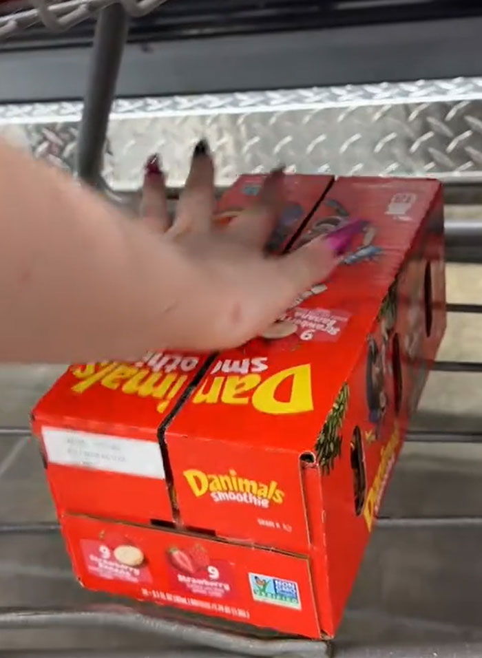 American parents filling a grocery cart with Danimals smoothies. American parents filling a grocery cart with Danimals smoothies.
