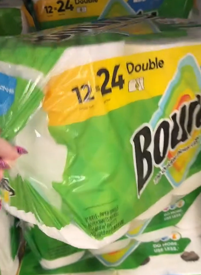 American parents shopping for groceries, holding a large pack of Bounty paper towels. American parents shopping for groceries, holding a large pack of Bounty paper towels.