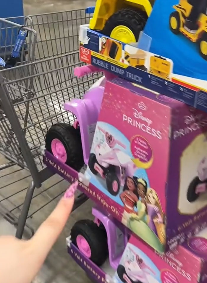 A shopping cart filled with toys, including a Disney Princess ride-on and a Rubble dump truck, for American parents groceries. A shopping cart filled with toys, including a Disney Princess ride-on and a Rubble dump truck, for American parents groceries.