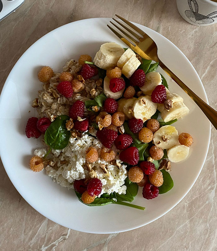 A plate of delicious groceries, including bananas, raspberries, spinach, and oats. A plate of delicious groceries, including bananas, raspberries, spinach, and oats.