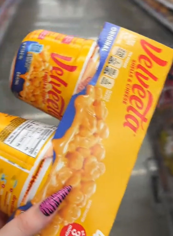 American parents fill grocery cart with Velveeta mac & cheese. People look for actual food. American parents fill grocery cart with Velveeta mac & cheese. People look for actual food.