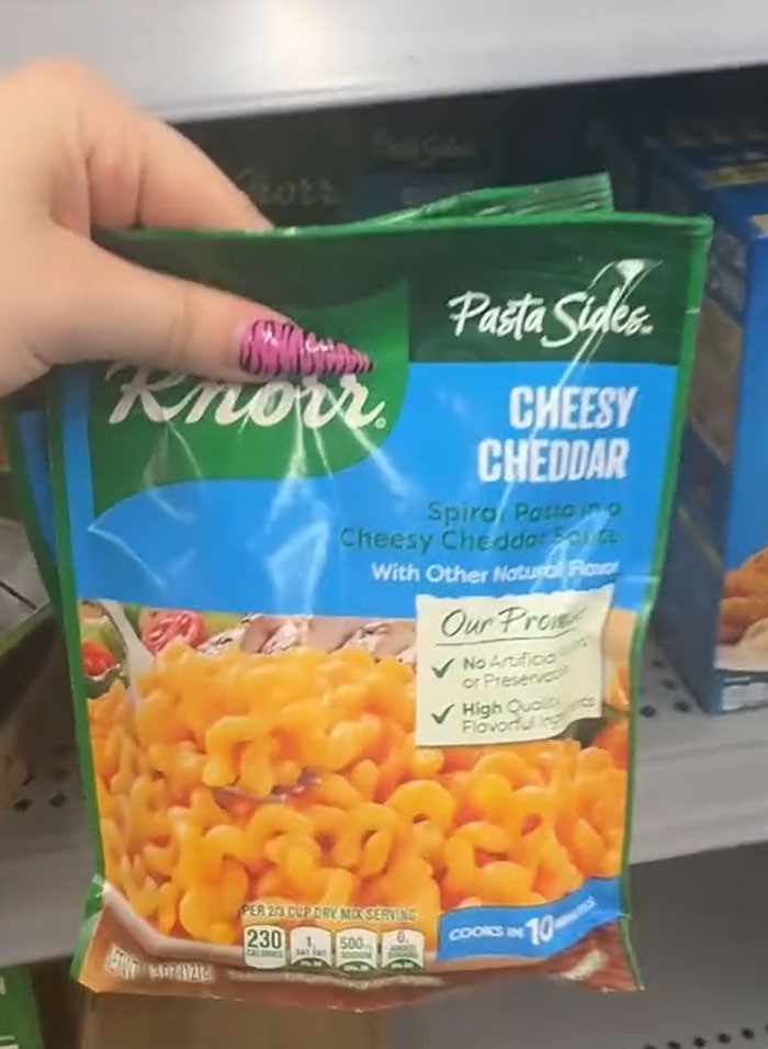 American parents fill their grocery cart with Knorr Pasta Sides Cheesy Cheddar, searching for actual food. American parents fill their grocery cart with Knorr Pasta Sides Cheesy Cheddar, searching for actual food.