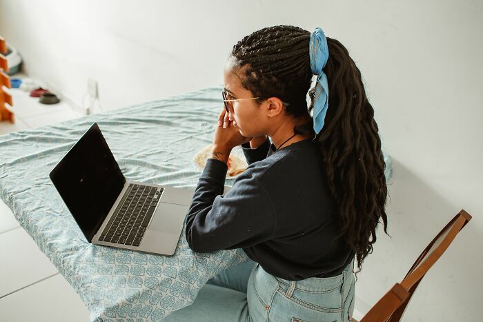 A young person at a laptop, a kid trying to live their life, possibly dealing with controlling parents.