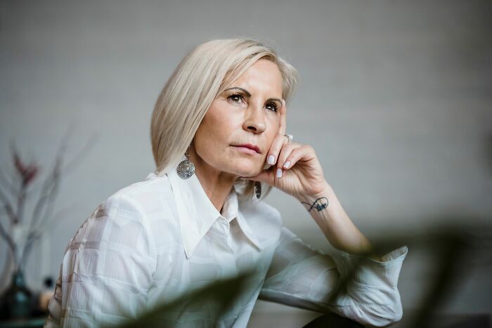 A thoughtful parent, deep in thought about heartbreaking stories, reflecting on letting kids live their lives freely.
