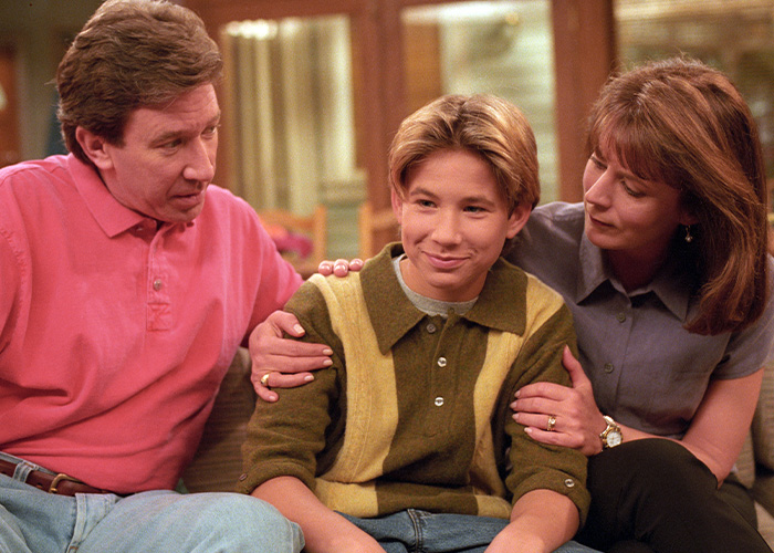 Tim Allen and Patricia Richardson comfort a young Jonathan Taylor Thomas on the set of Home Improvement.