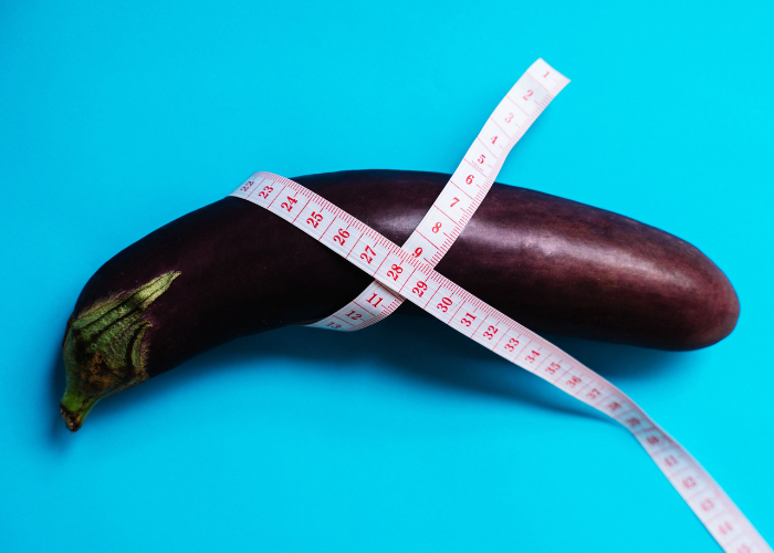 Eggplant wrapped in a measuring tape representing men's private parts