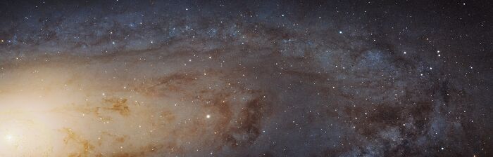 A panoramic view of a distant galaxy with countless stars and nebulae, showcasing cool facts about the universe's vastness.
