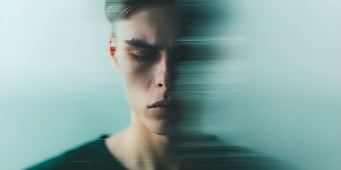 A man with a blurred face suggesting a feeling of extreme illness and sickness.