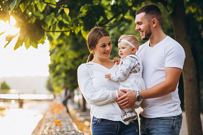 Wife hides money: A happy family, husband, wife, and baby, enjoying a sunny day outdoors. Wife hides money: A happy family, husband, wife, and baby, enjoying a sunny day outdoors.