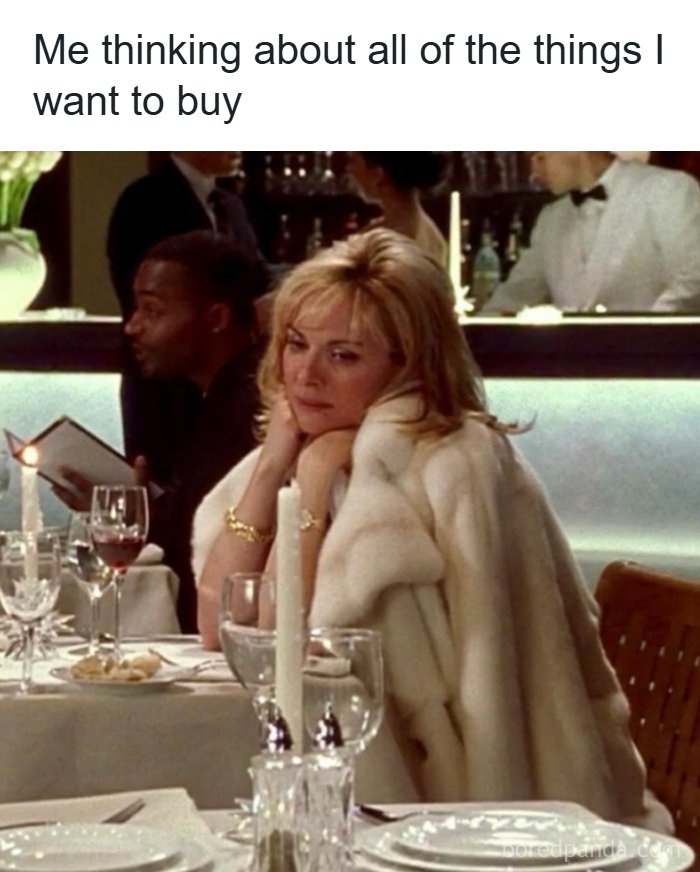 A meme of Samantha Jones from S*x and the City at a fancy restaurant, wearing a fur coat and looking bored. The caption reads, 'Me thinking about all of the things I want to buy.'