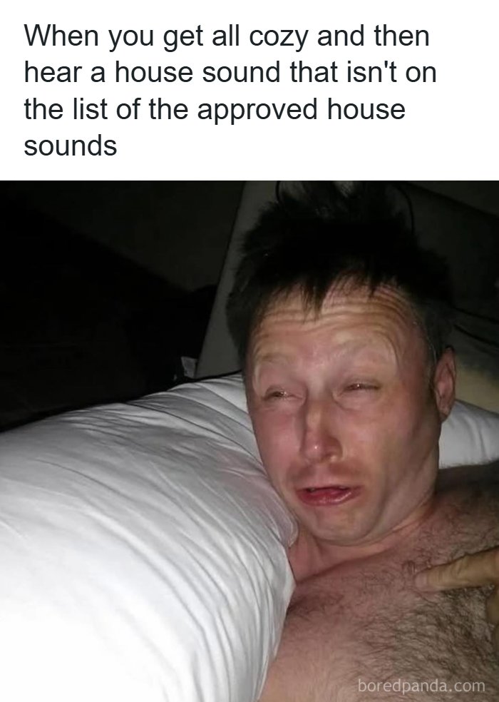 A man in bed, looking scared and pointing at his chest, representing a hilarious meme about house sounds.