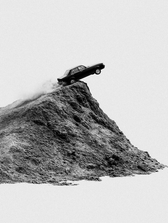 A black car on the brink of falling off a steep, dystopian cliff, an image by Marcus Wallinder.