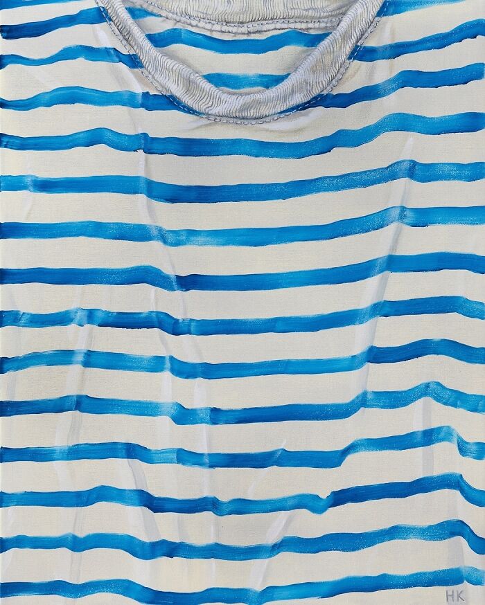 A white t-shirt with bold blue horizontal stripes, creating a striking portrait of identity.