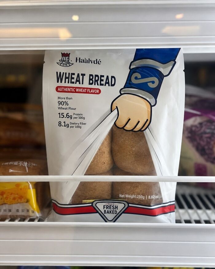 A bag of wheat bread with a graphic of a hand opening it, captured by photographers at a funny moment.
