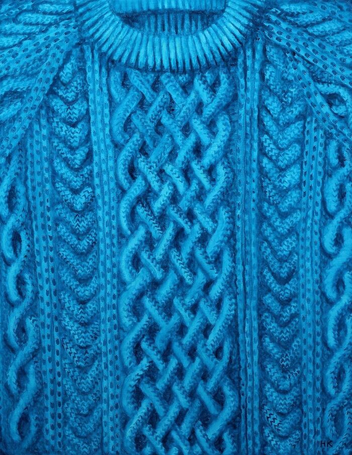 Artist creates striking portrait of identity with a bright blue, intricate cable-knit jumper showing textured patterns.
