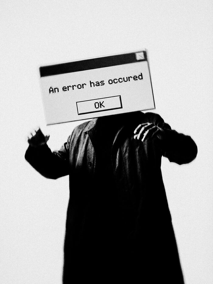 Person with a computer error message for a head, symbolizing a dystopian image of distorted reality.